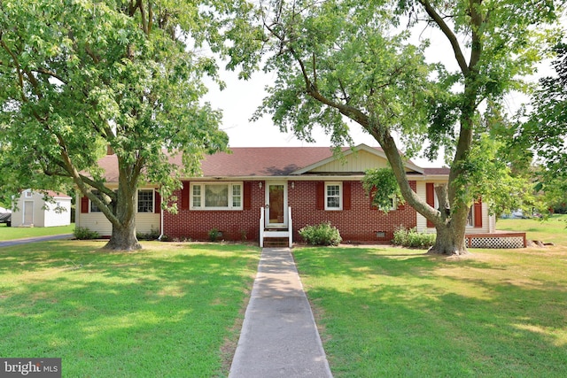 ranch-style home featuring crawl space, a shingled roof, a front yard, and brick siding