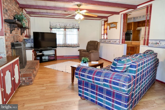 living area with light wood-type flooring, beam ceiling, and ceiling fan