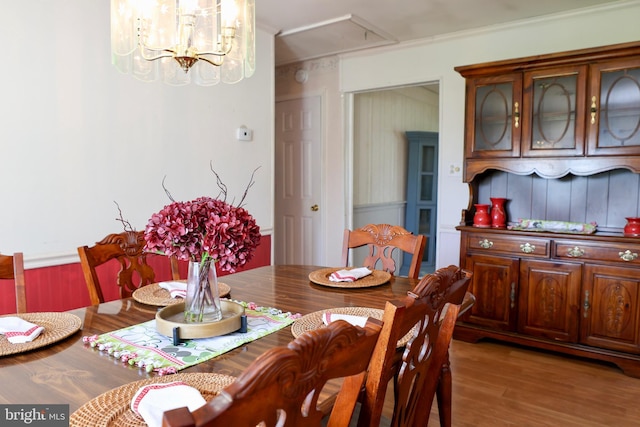 dining area with a notable chandelier and wood finished floors