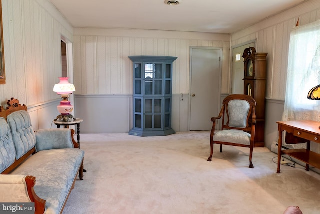 sitting room featuring light carpet and visible vents