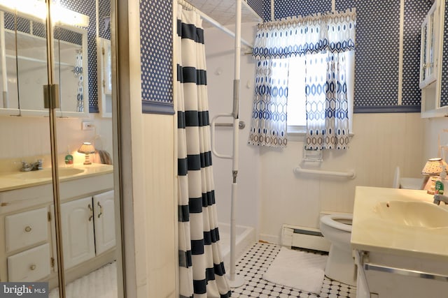 full bathroom featuring toilet, vanity, and baseboard heating