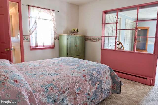 bedroom with a baseboard radiator and light colored carpet