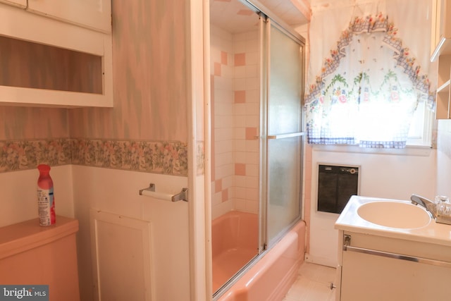 bathroom featuring enclosed tub / shower combo and vanity