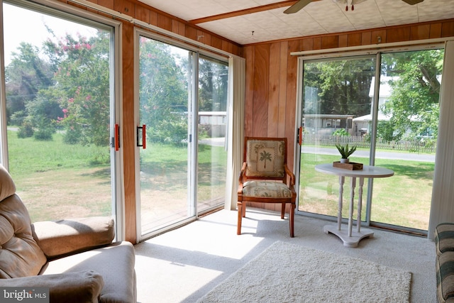 sunroom / solarium with a ceiling fan