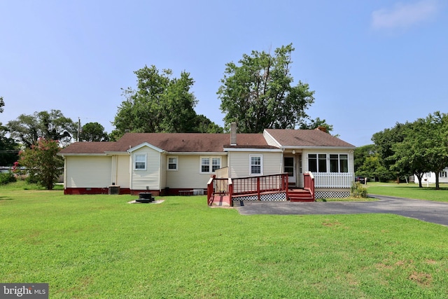 view of front of house with a deck and a front lawn