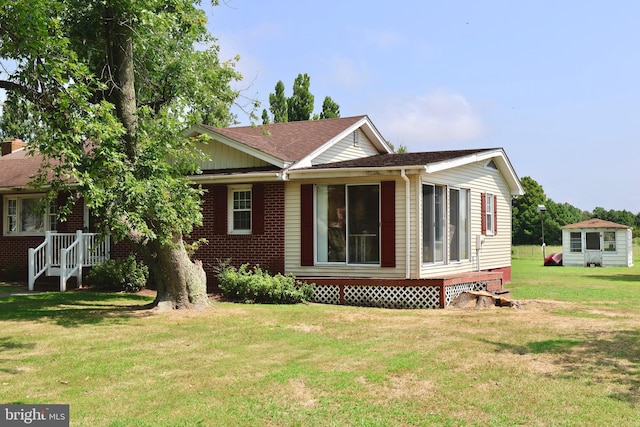 view of side of property featuring a lawn and brick siding