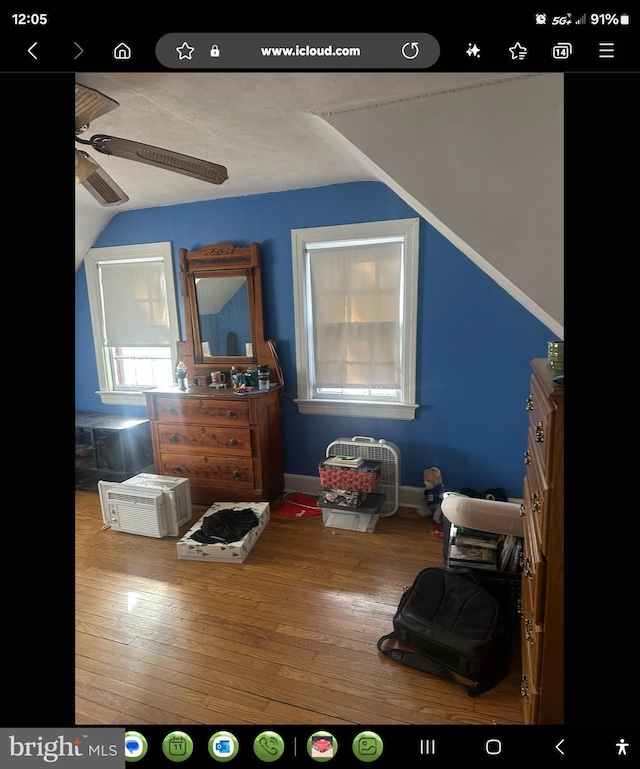 bedroom with hardwood / wood-style flooring and lofted ceiling