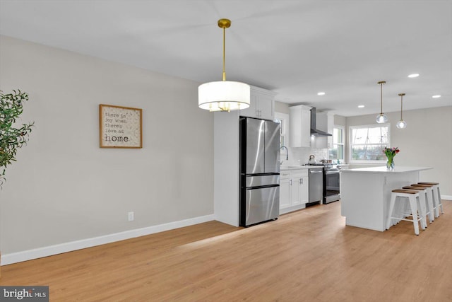 kitchen with white cabinetry, decorative light fixtures, stainless steel refrigerator, and range