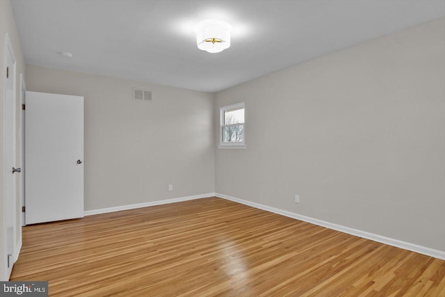 spare room featuring light wood-type flooring