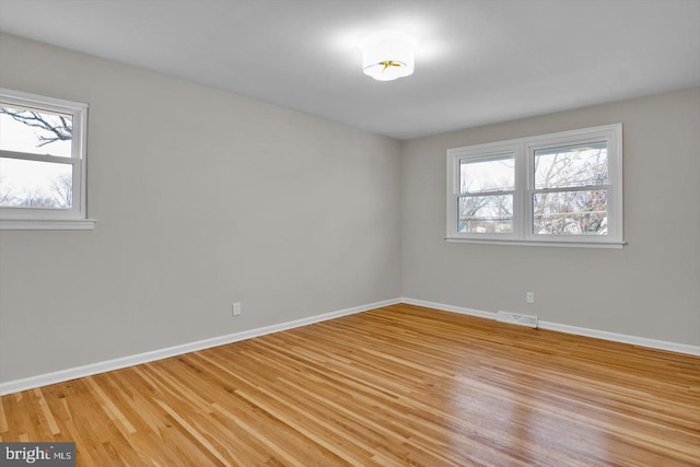 spare room featuring light hardwood / wood-style floors