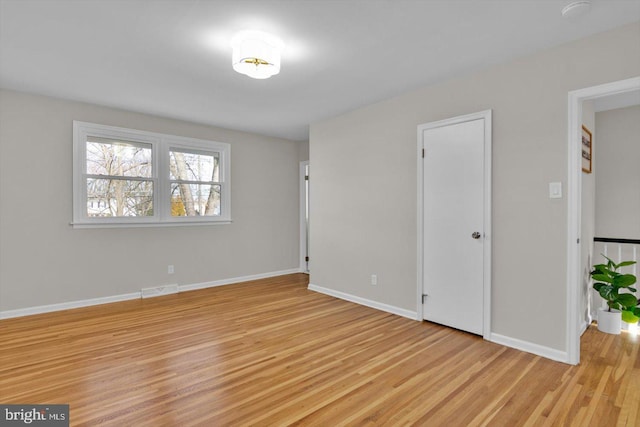 empty room with light hardwood / wood-style floors