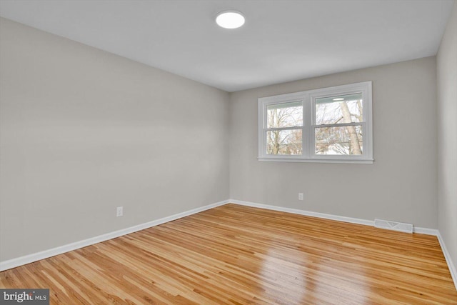 spare room featuring light wood-type flooring