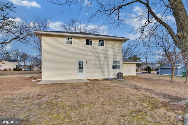 back of house featuring cooling unit and a yard