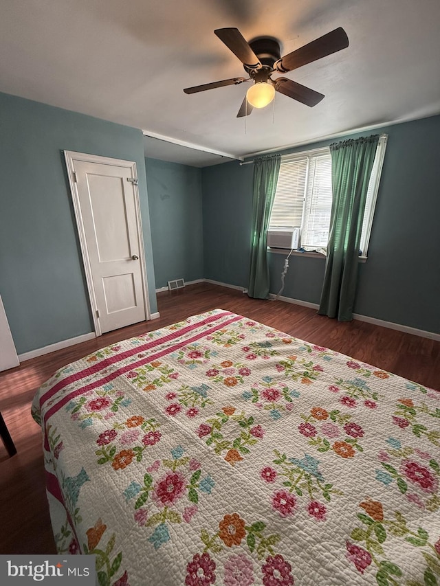 bedroom with ceiling fan and dark hardwood / wood-style flooring