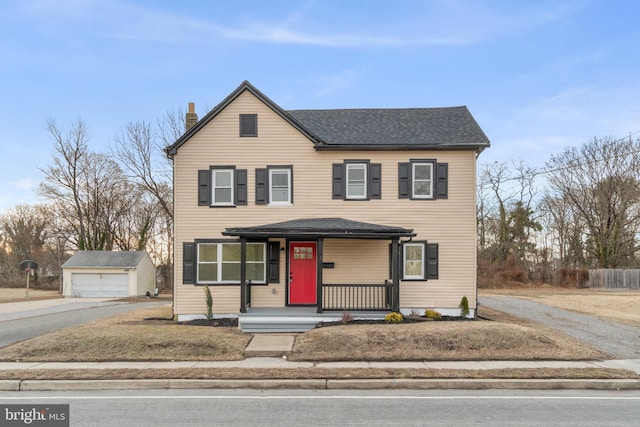 front of property featuring an outbuilding, a garage, and covered porch