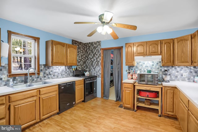 kitchen featuring sink, gas range, tasteful backsplash, light wood-type flooring, and dishwasher