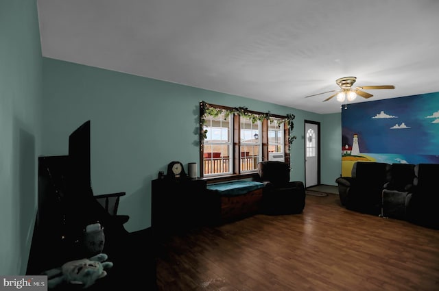 living room featuring dark hardwood / wood-style floors and ceiling fan