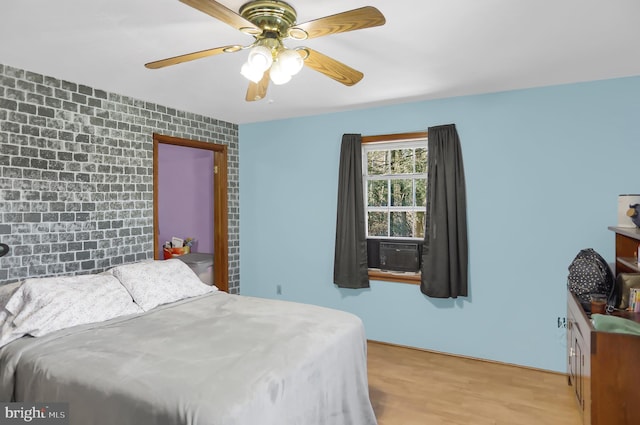 bedroom with light hardwood / wood-style flooring and ceiling fan