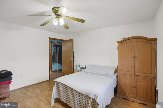 bedroom with a closet, ceiling fan, and light hardwood / wood-style flooring