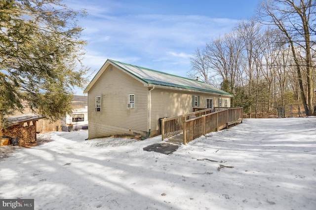 snow covered house with a deck