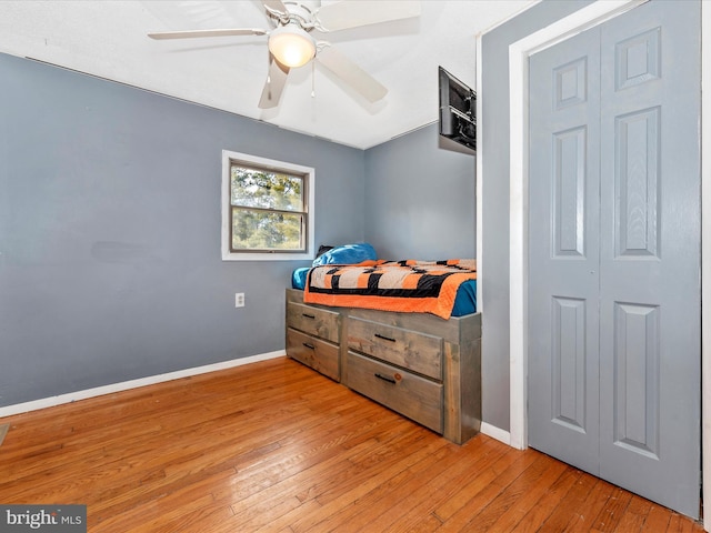 bedroom with ceiling fan and light hardwood / wood-style floors