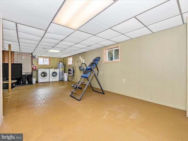 workout room with water heater, separate washer and dryer, and a paneled ceiling