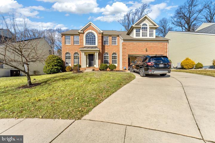 view of front of home featuring a garage and a front lawn