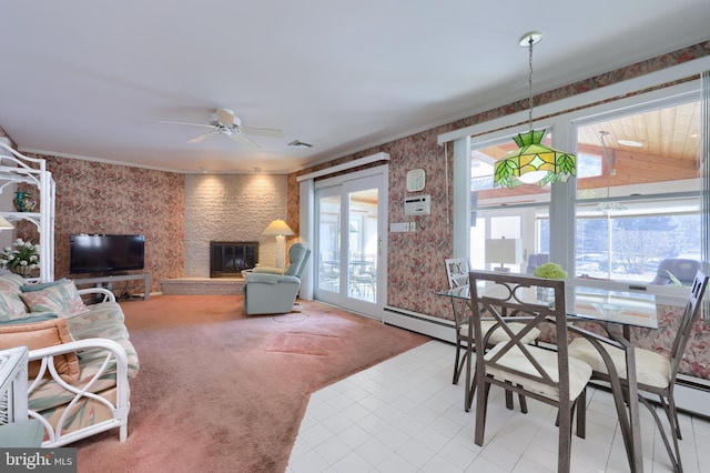 living room featuring ceiling fan, a large fireplace, and carpet