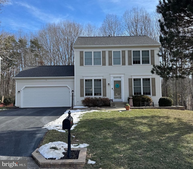 view of front of house with a garage and a front lawn