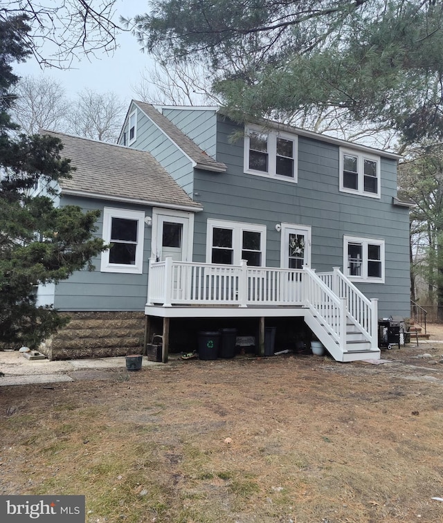 exterior space with a deck and a front yard