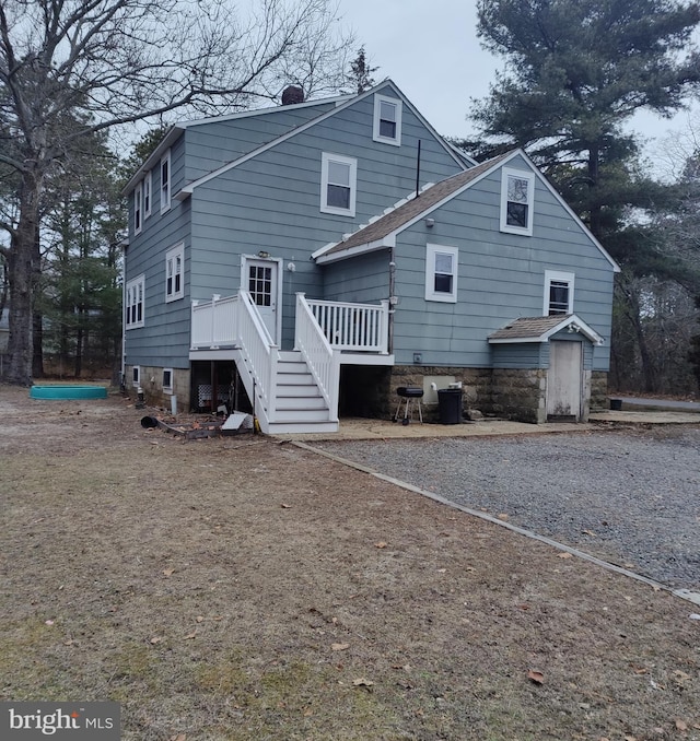 back of property featuring a deck