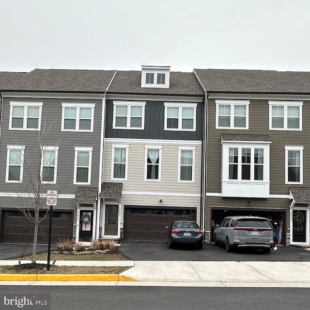 townhome / multi-family property featuring an attached garage and driveway