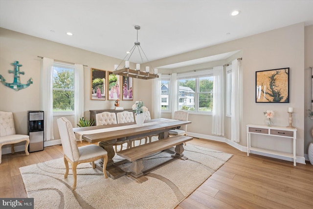 dining area with recessed lighting, plenty of natural light, light wood-style flooring, and baseboards