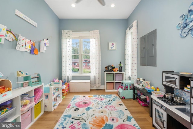 game room featuring electric panel, recessed lighting, light wood-type flooring, and ceiling fan