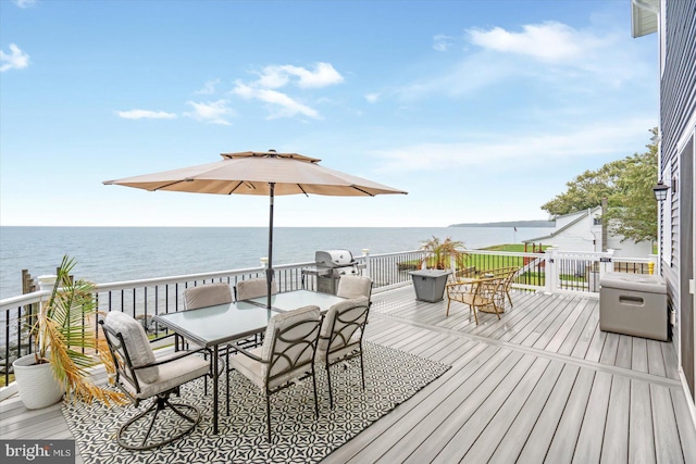 wooden terrace featuring outdoor dining area, a water view, and area for grilling