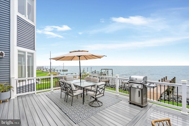 wooden terrace with a water view and a grill