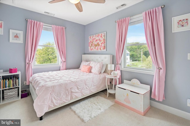 bedroom with ceiling fan, carpet floors, and multiple windows