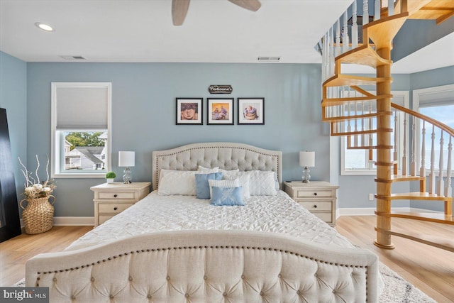 bedroom featuring light hardwood / wood-style floors and ceiling fan