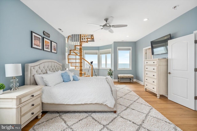 bedroom with ceiling fan and light hardwood / wood-style floors