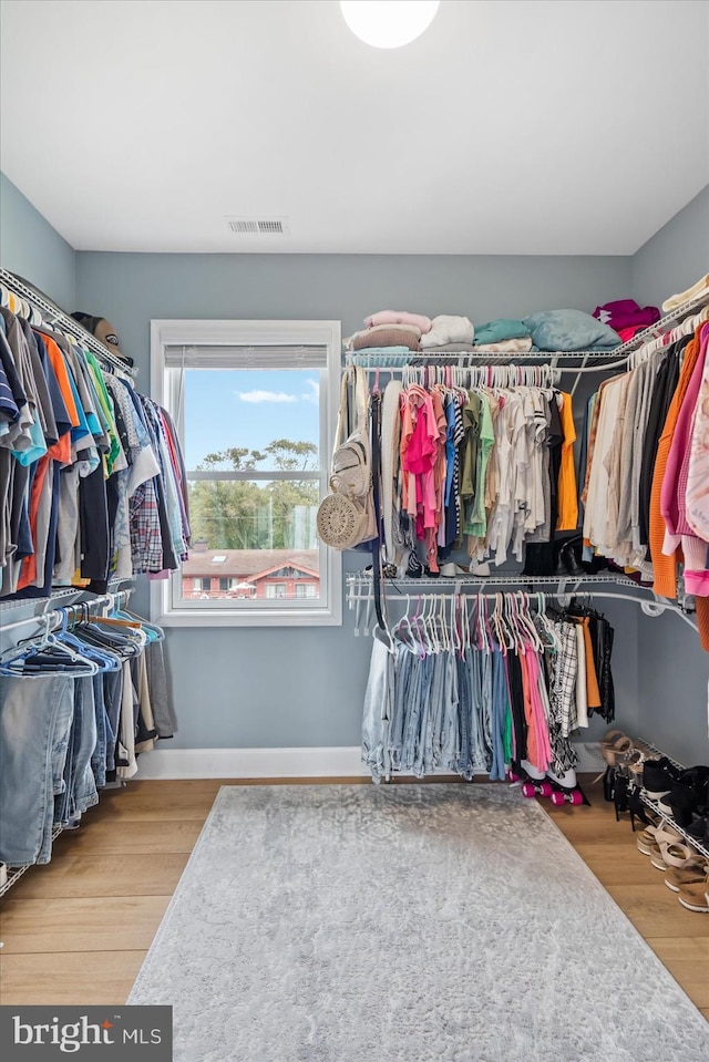 spacious closet with visible vents and wood finished floors