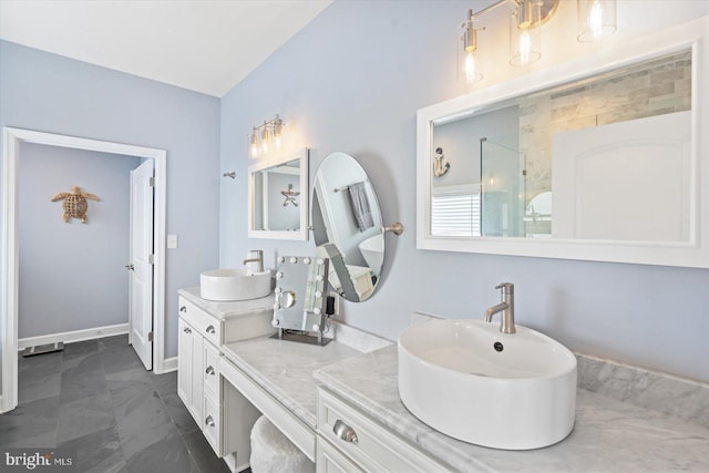 full bathroom with a sink, baseboards, a shower, and double vanity