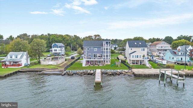 exterior space featuring a residential view and a water view