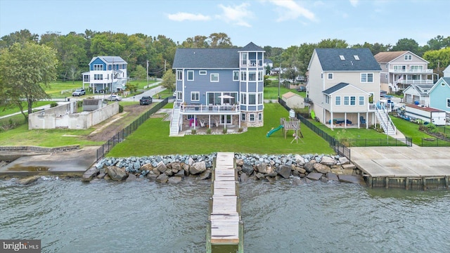 back of house featuring a playground and a water view