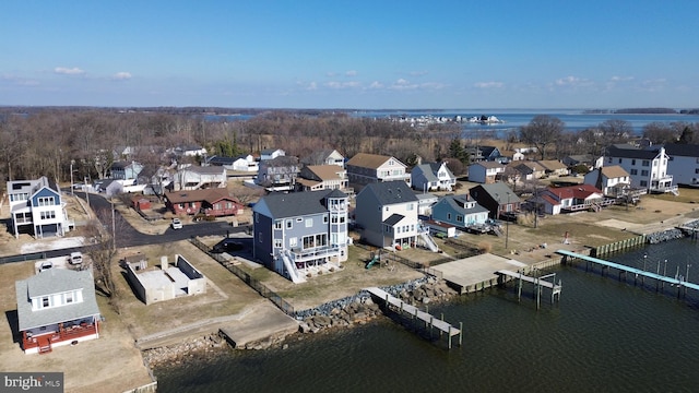 drone / aerial view with a residential view and a water view