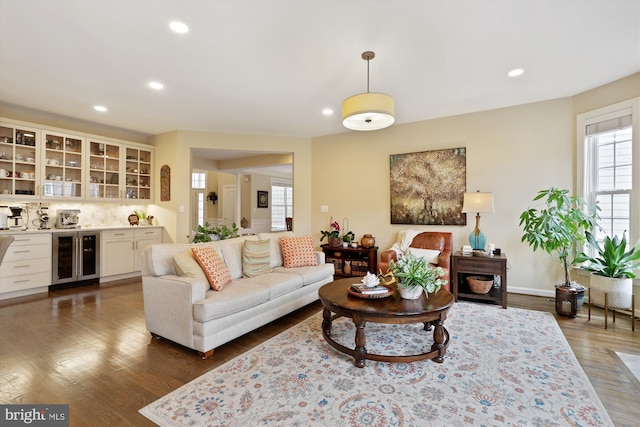 living room with beverage cooler, dark wood-style floors, and recessed lighting