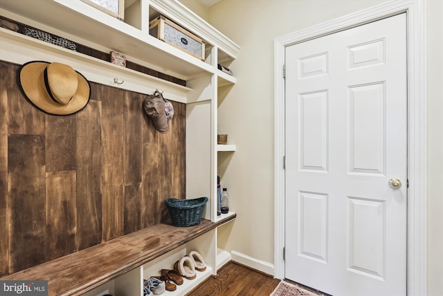 mudroom featuring dark wood finished floors and baseboards