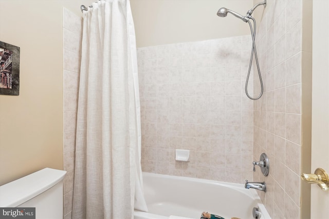 full bath with toilet and shower / bath combo with shower curtain