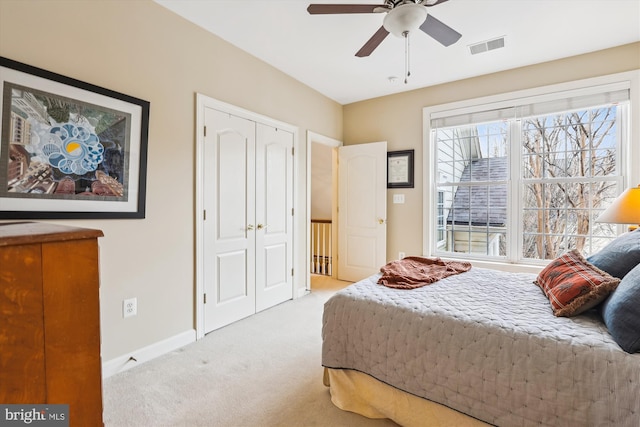 carpeted bedroom featuring visible vents, ceiling fan, and baseboards