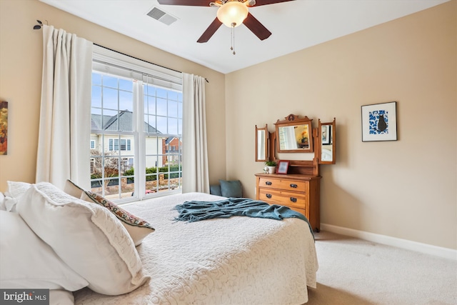 bedroom with visible vents, baseboards, carpet, and a ceiling fan