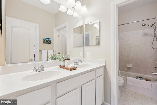 full bath with tile patterned flooring, washtub / shower combination, toilet, and a sink